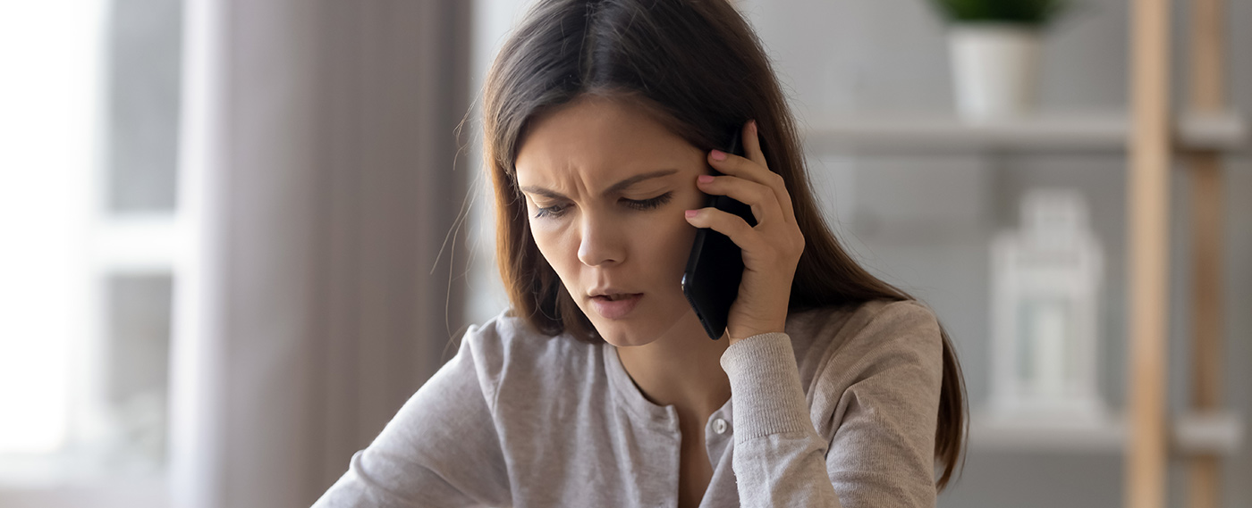 a worried woman on the phone