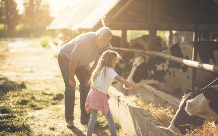 young girl and grandpa farming