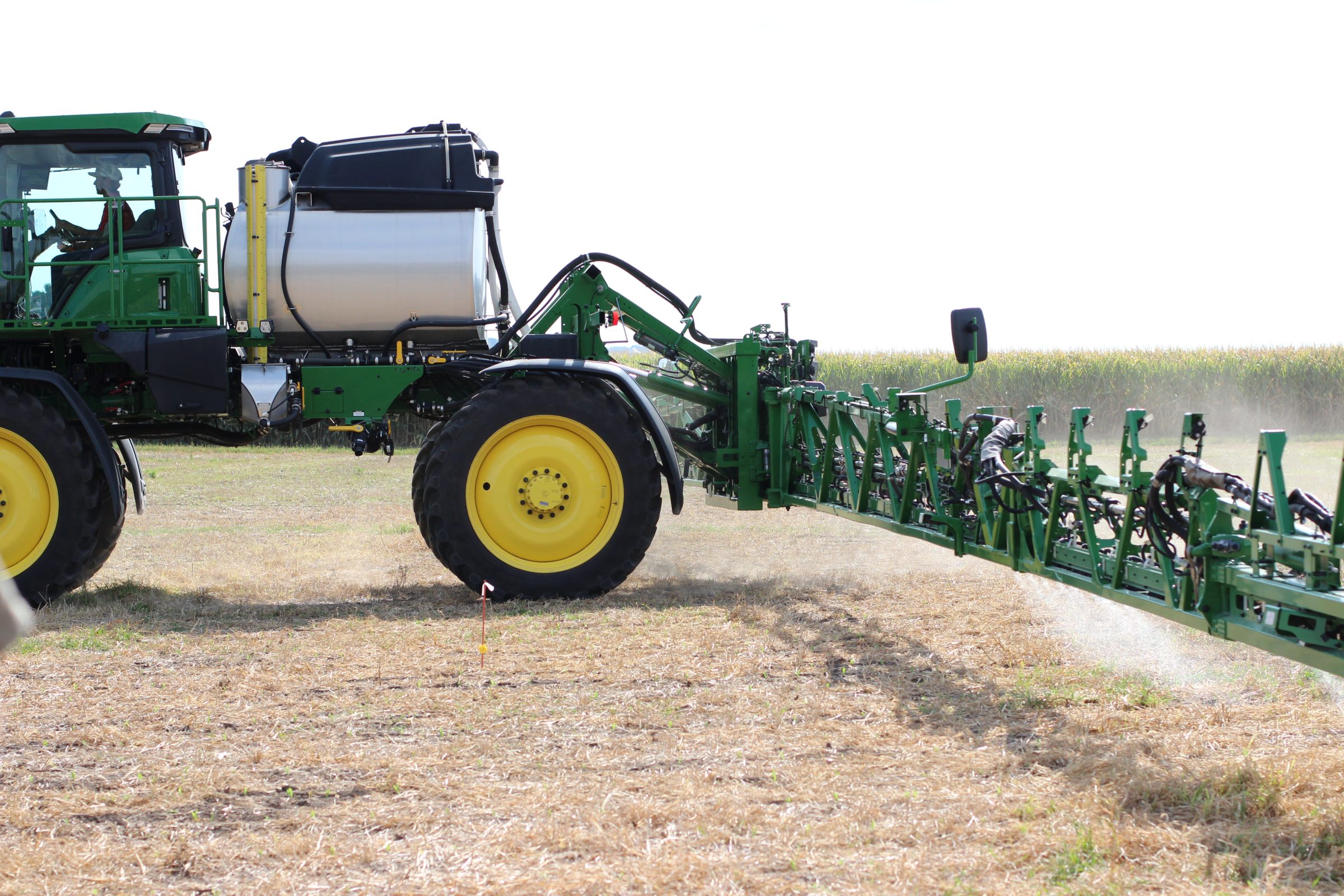 A John Deere sprayer applying chemicals in a demonstration plot at the Arlington Agricultural Research Station